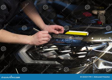 Installation of a Protective Film on the Headlights of the Car.Car Body Protection Stock Image ...