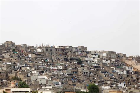 Slum housing stands on a hill in the Orangi town area of Karachi Pakistan