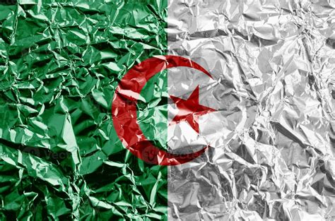 Algeria flag depicted in paint colors on shiny crumpled aluminium foil ...