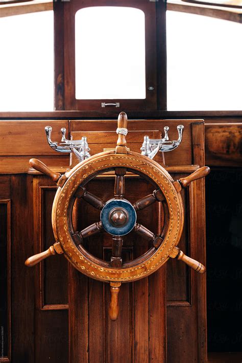 wooden helm on a boat by Gillian Vann - Stocksy United