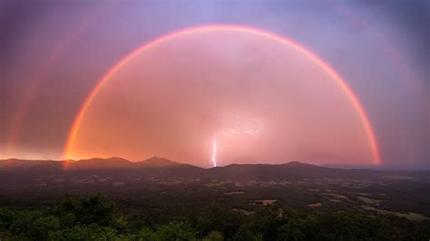 Photographer combines luck and skill in this incredible double rainbow and lightning shot