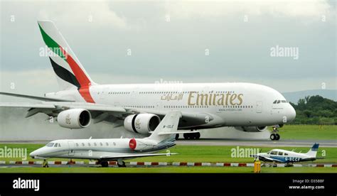 Emirates Airlines Airbus A380 861 E6 EDK lands on a wet runway at ...