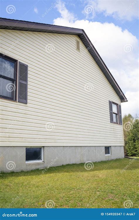 House with Pale Yellow Vinyl Siding Stock Image - Image of suburban, house: 154920347