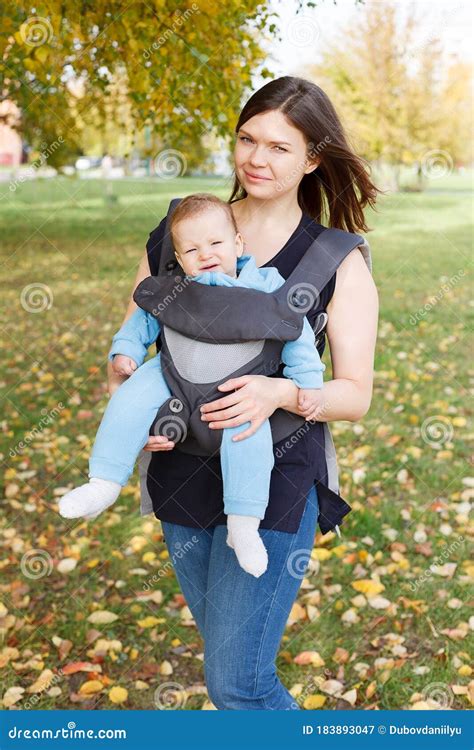 Little Toddler Baby Sits in the Sling Ergorace Mom, Carrying Child in an Upright Position ...