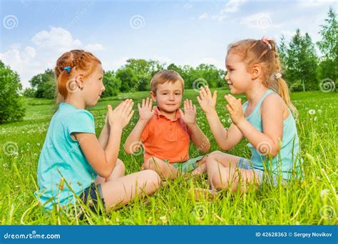 Three Kids Playing on a Grass Stock Image - Image of kids, look: 42628363