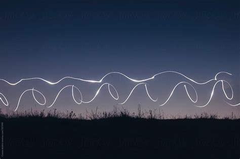 "Light Trails Painting On Hill After Sunset" by Stocksy Contributor "Cosma Andrei" - Stocksy