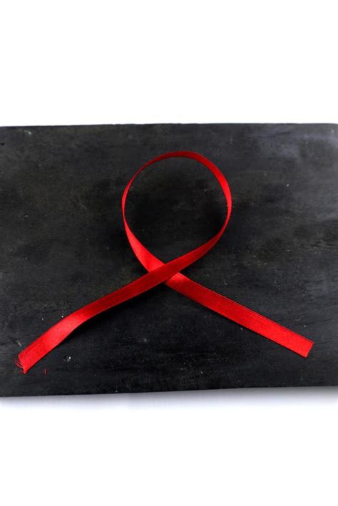 red aids ribbon on old wood background 15106323 Stock Photo at Vecteezy