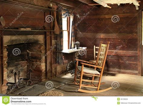 Historic Log Cabin Interior with Rocking Chair and Fireplace