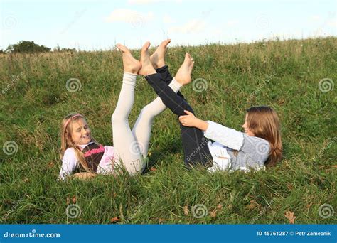 Girls Lying In Grass Stock Image | CartoonDealer.com #45761287