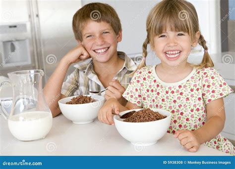 Two Young Children in Kitchen Eating Cereal Stock Photo - Image of diet, sugary: 5938308