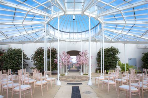 The Conservatory at Chiswick House Gardens set up for a wedding ceremony. Chiavari Chairs set in ...