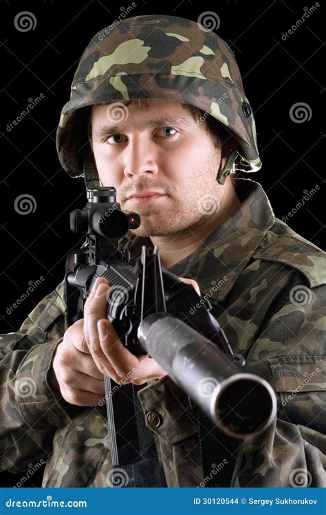 Soldier Holding A Gun In Studio Stock Photo - Image: 30120544