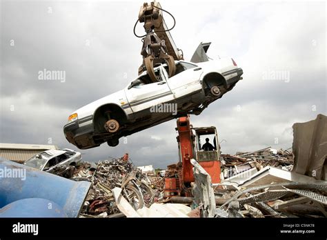 Crane lifting car for scrap metal during the recycling process in a ...