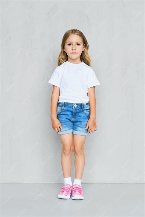 Premium Photo | Little child girl in white t-shirt, jeans shorts and ...