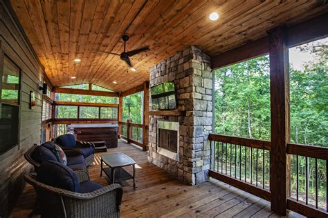 Broken Bow Cabins Texas Time furniture and fireplace on covered patio ...