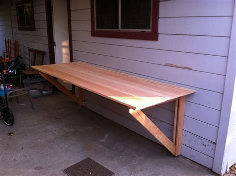 DIY table top, legs fold under and top folds flush against wall. Total thickness about 3 inches ...
