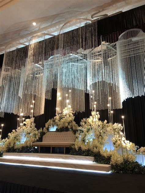 Elegant Wedding Stage with Chandeliers and Flowers