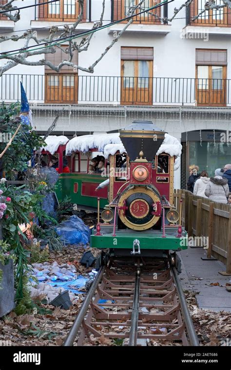 Children ride a miniature snow-covered steam train at Torrejon de Ardoz ...