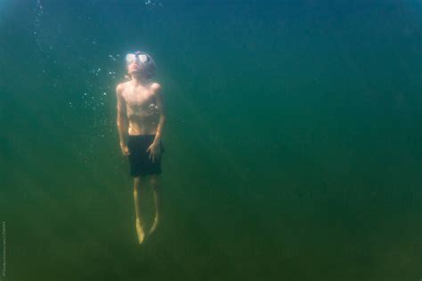 "Little Boy Swimming To Surface In Deep Green Freshwater Lake" by ...