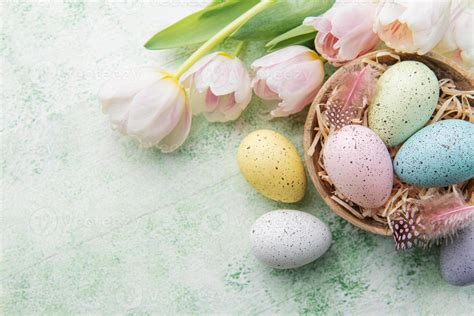 Bowl with Easter eggs painted pastel colors on a green wooden background. 20242009 Stock Photo ...