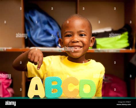 Child smiling with play-play alphabet letters Stock Photo - Alamy