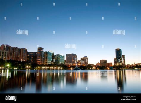 Orlando Florida city skyline at night reflected on Lake Eola Stock ...