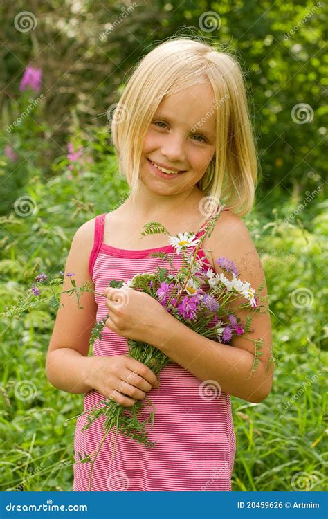 Smiling Girl with Flowers stock photo. Image of gardering - 20459626