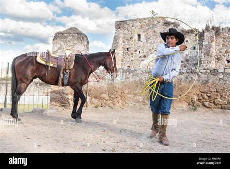 A Mexican charro or cowboy practices roping skills with his horse at a hacienda ranch in Alcocer ...