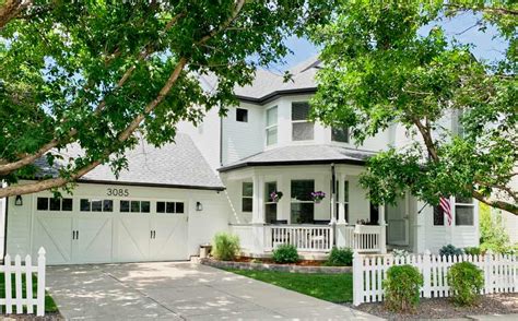 Discover the Charm of a White Farmhouse with Blue Shutters - See Stunning Photos Inside!