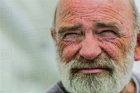 Close up of wrinkled face of Caucasian man - Stock Photo - Dissolve