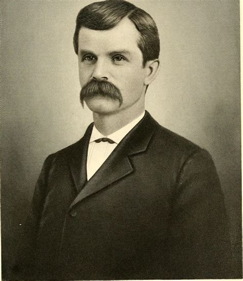 an old black and white photo of a man in a suit with a moustache