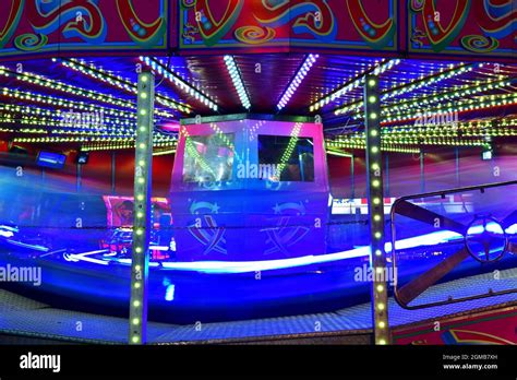 The Waltzer traditional fairground ride at night Stock Photo - Alamy