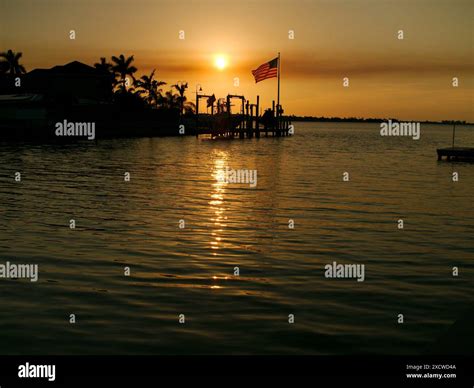 Sunset Silhouette of US Flag looking NW Boca Ciega Bay near bridge at ...