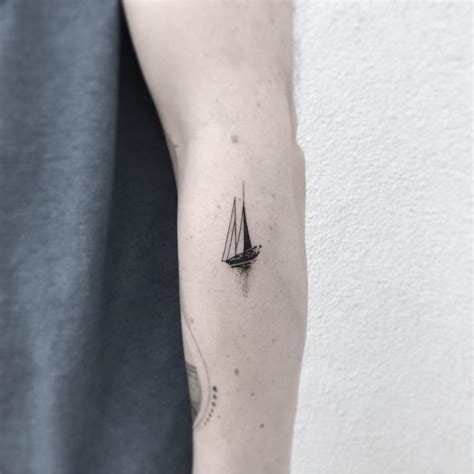 Small boat tattoo on the left forearm - Tattoogrid.net