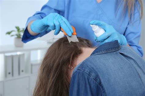 Premium Photo | Doctor using nit comb and spray on girl39s hair indoors ...