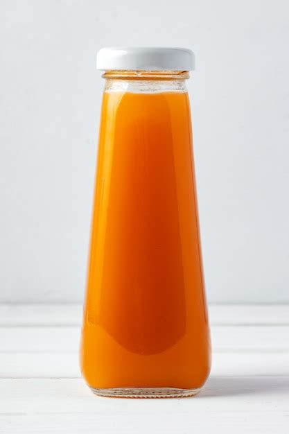 Premium Photo | Small glass bottle of fresh juice on white background