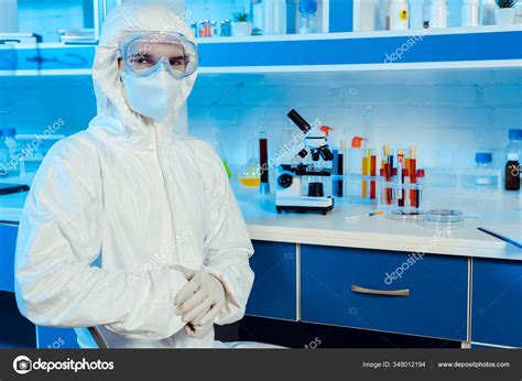 Scientist Hazmat Suit Goggles Standing Microscope — Stock Photo © IgorVetushko #348012194