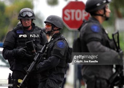 Miami SWAT team members stand in front of a home that was raided ...