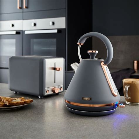 a tea kettle sitting on top of a kitchen counter next to toaster ovens