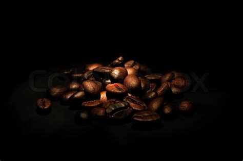 Heap of coffee beans on black background | Stock Photo | Colourbox