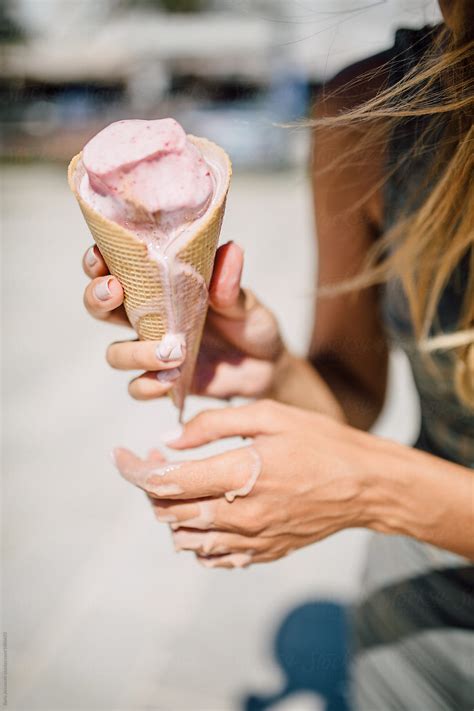 Woman Holding A Melting Ice Cream | Stocksy United