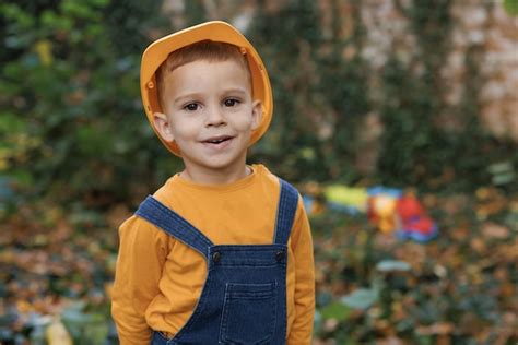 Premium Photo | Portrait of kid boy builder wearing protective yellow ...