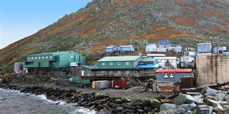 a group of buildings sitting on top of a rocky hillside next to the ...