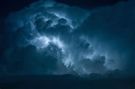 Blue Lightning Strike Surrounded By Storm Clouds Stock Photo - Download ...