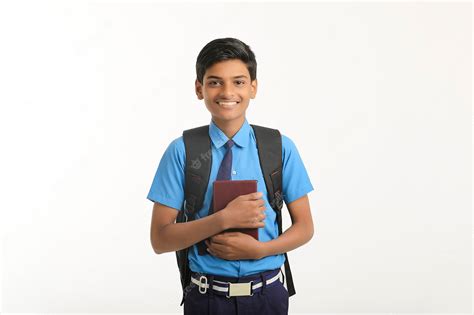 Premium Photo | Indian school boy in uniform and holding diary in hand on white background