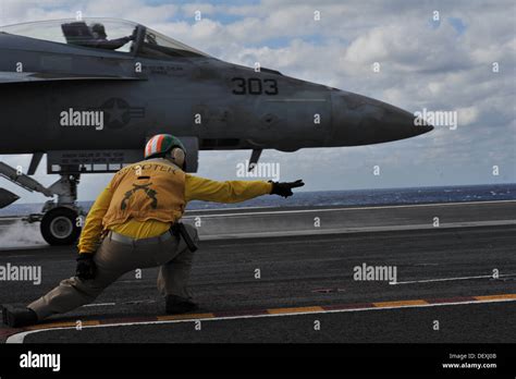 A shooter aboard the aircraft carrier USS Theodore Roosevelt (CVN 71 ...