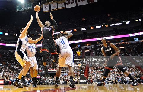 Miami Heat's Dwyane Wade goes up between several Orlando Magic... News Photo - Getty Images