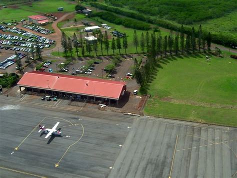 Molokai Airport - aerial view of the entrance, parking lot, main terminal and one plane - a ...