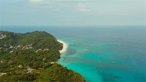 Premium Photo | The famous tropical island of boracay with white beach hotels among the forest ...