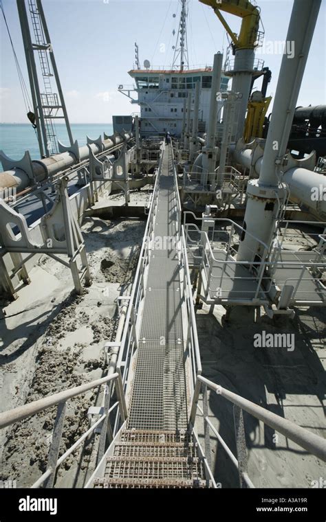 Sand loaded into hopper of a Trailing Suction Hopper Dredger at work ...